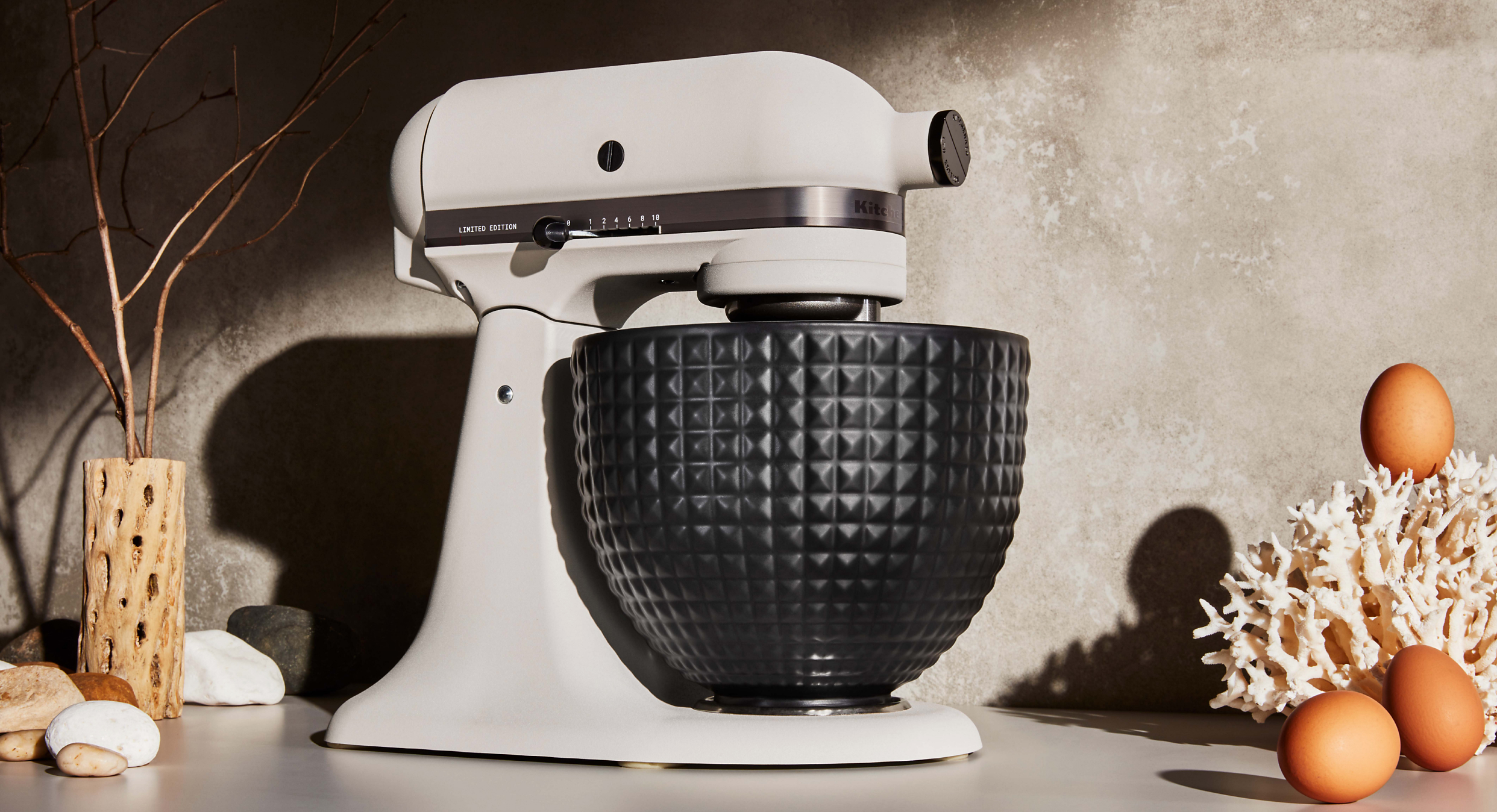 Stand mixer with ceramic bowl on a cement background 