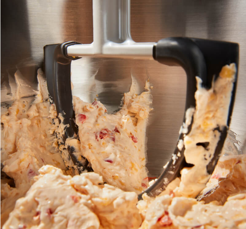 The interior of a KitchenAid® bowl-lift stand mixer mixing up dough.