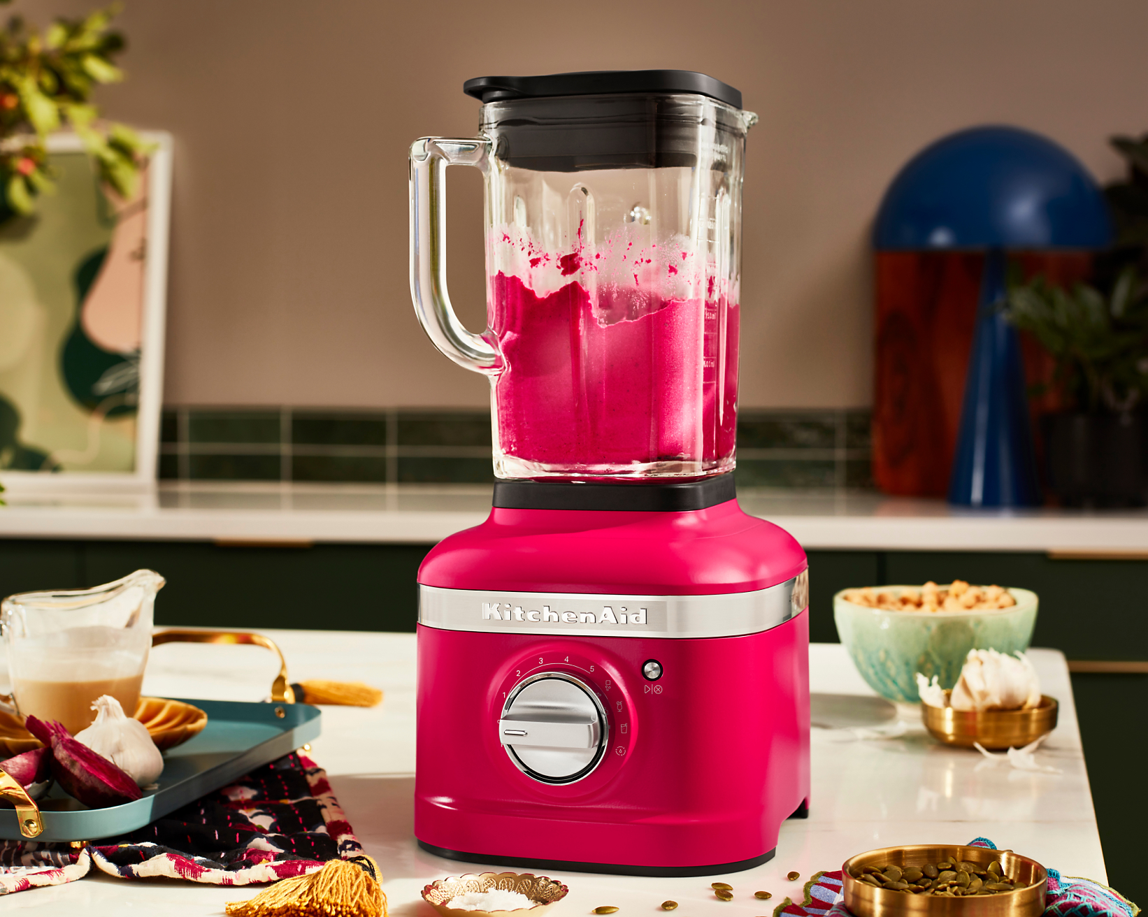 A K400 Blender in Hibiscus blending a bold pink beverage.