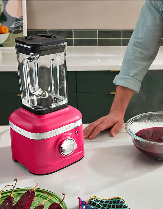 A K400 Speed Blender in Hibiscus blending chiles and hibiscus flowers.