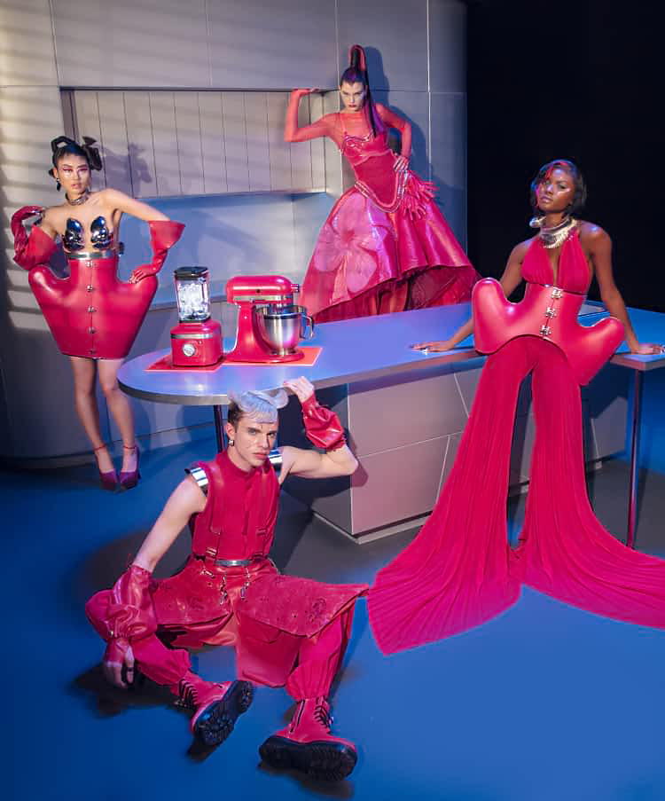 A group of models posing in a kitchen wearing designs from Marta Del Rio's New York Fashion Week Collection.