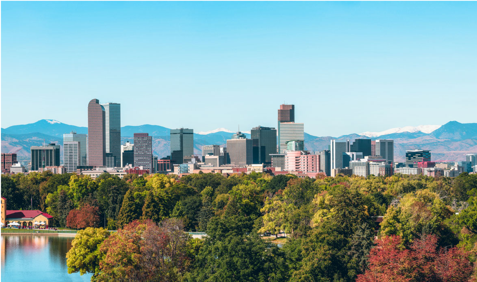 The city of Denver surrounded by picturesque mountains and colorful trees.