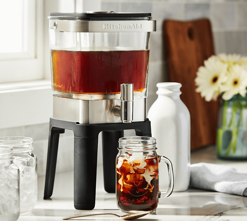 A KitchenAid® cold brew maker pouring cold brew into a glass cup.