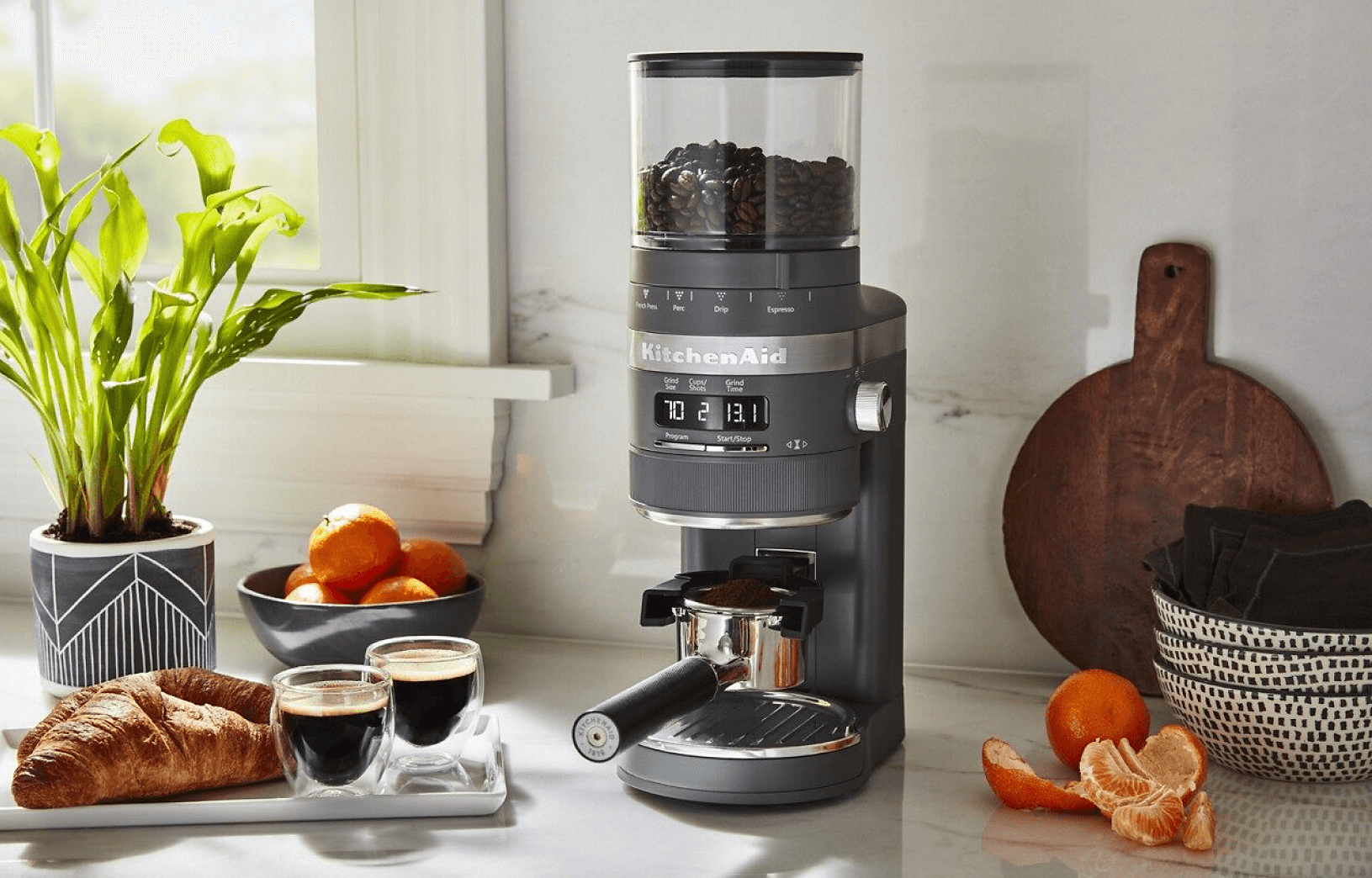 A KitchenAid® Burr Coffee Grinder resting on a bright counter.