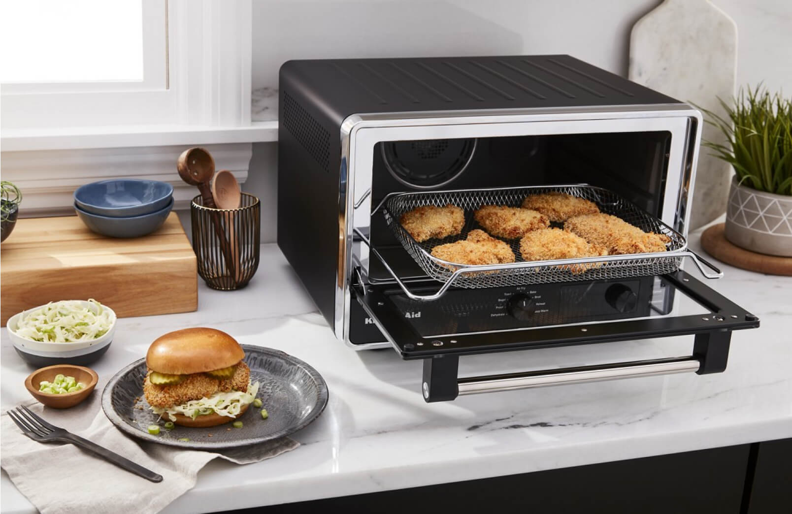 A KitchenAid® Digital Countertop Oven with Air Fry frying chicken.