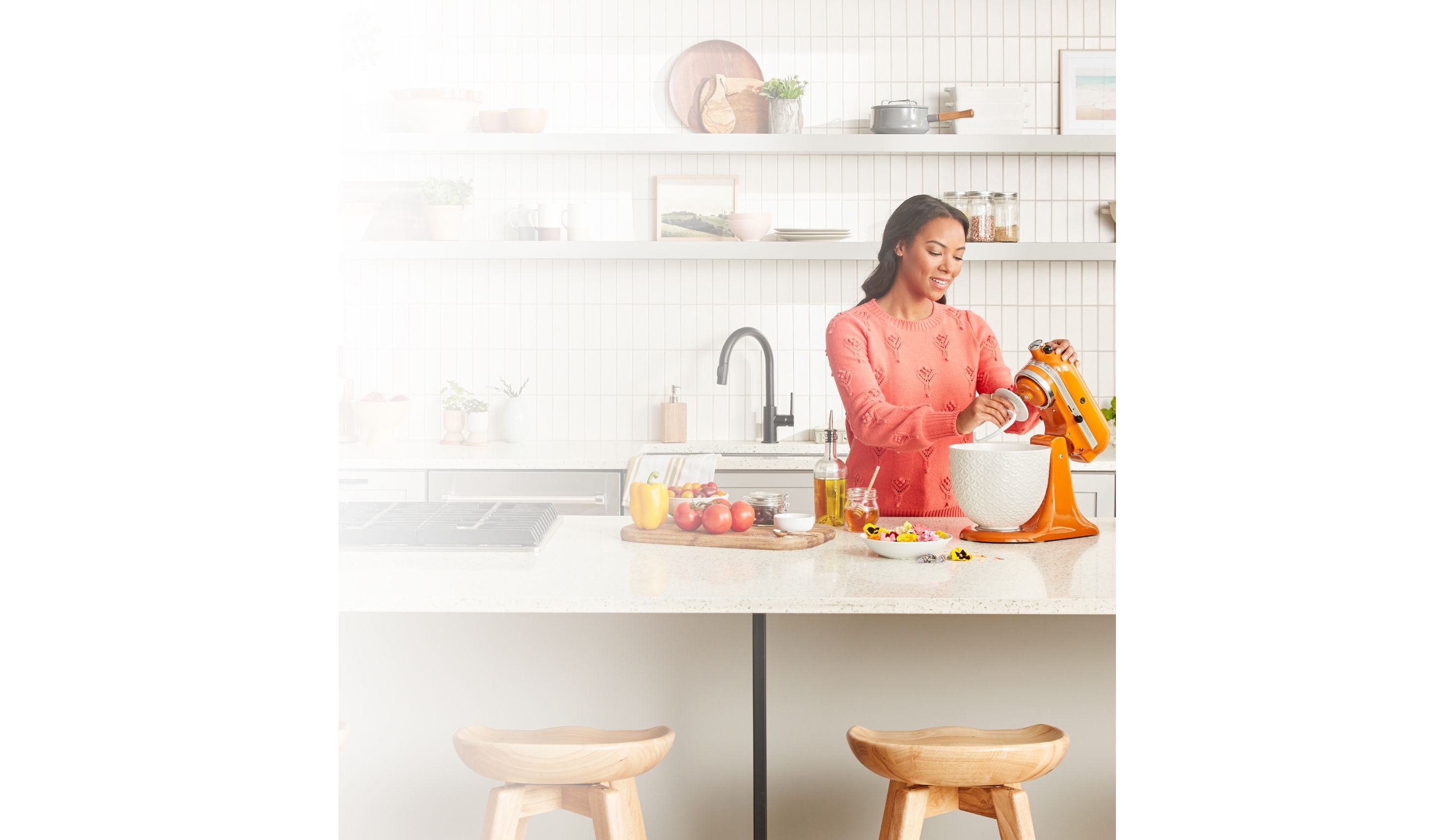 Woman with KitchenAid® Artisan® Series Stand Mixer and fresh vegetabes