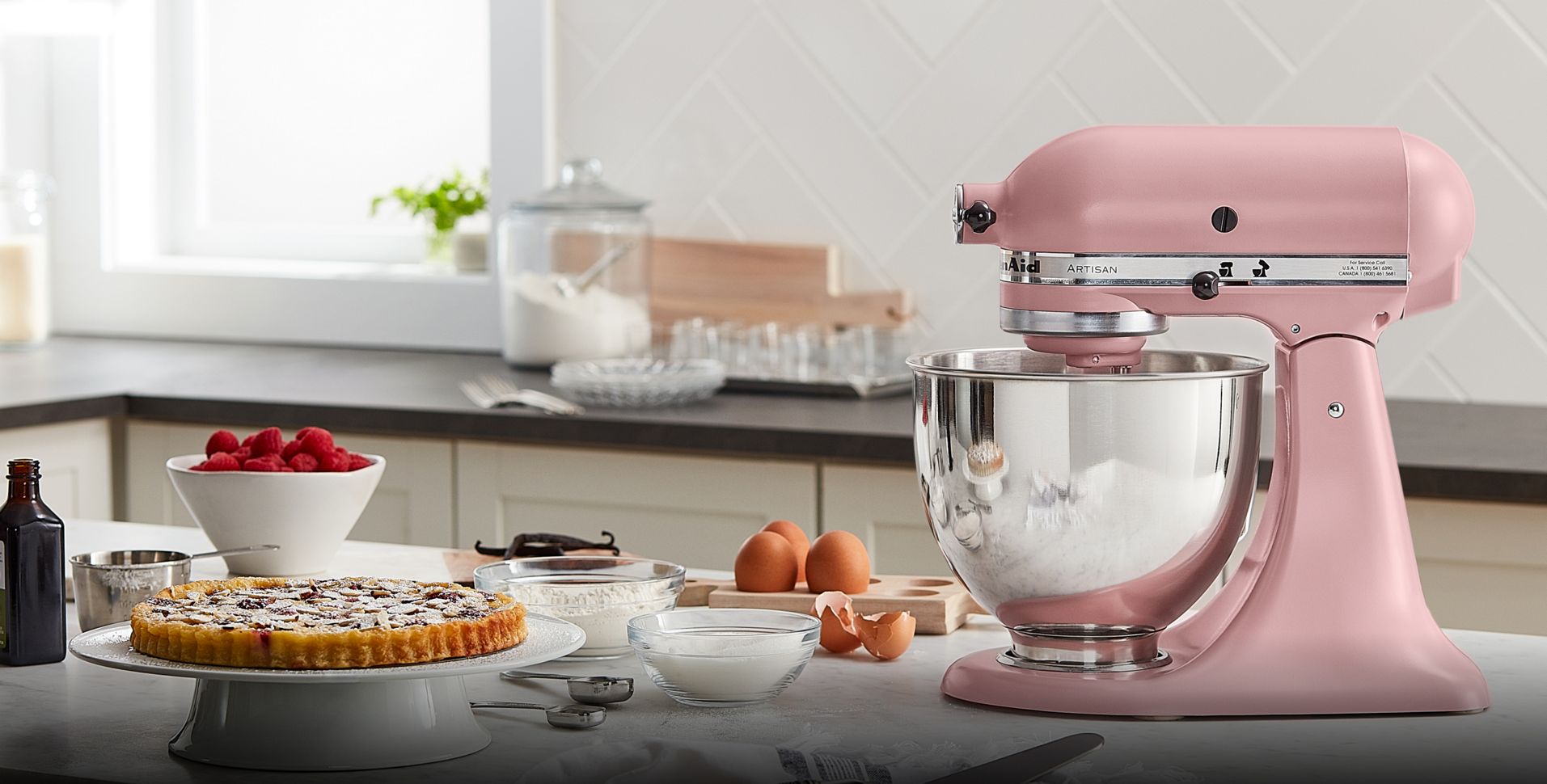 A KitchenAid® Stand Mixer side profile with berries, eggs and baked goods
