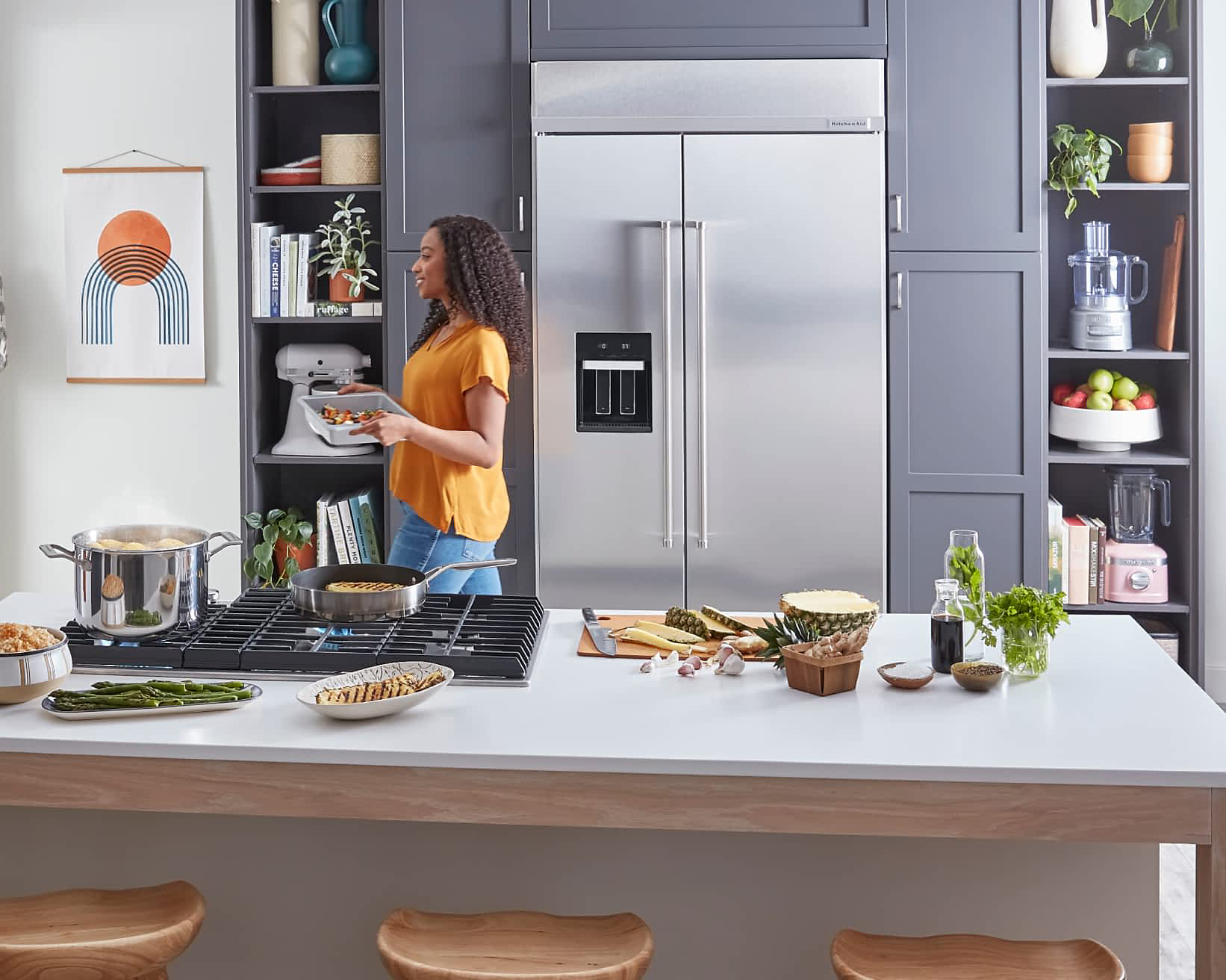 A maker in a kitchen filled with KitchenAid® appliances. 