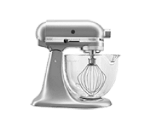 A KitchenAid® Stand Mixer with a whisk and clear bowl.