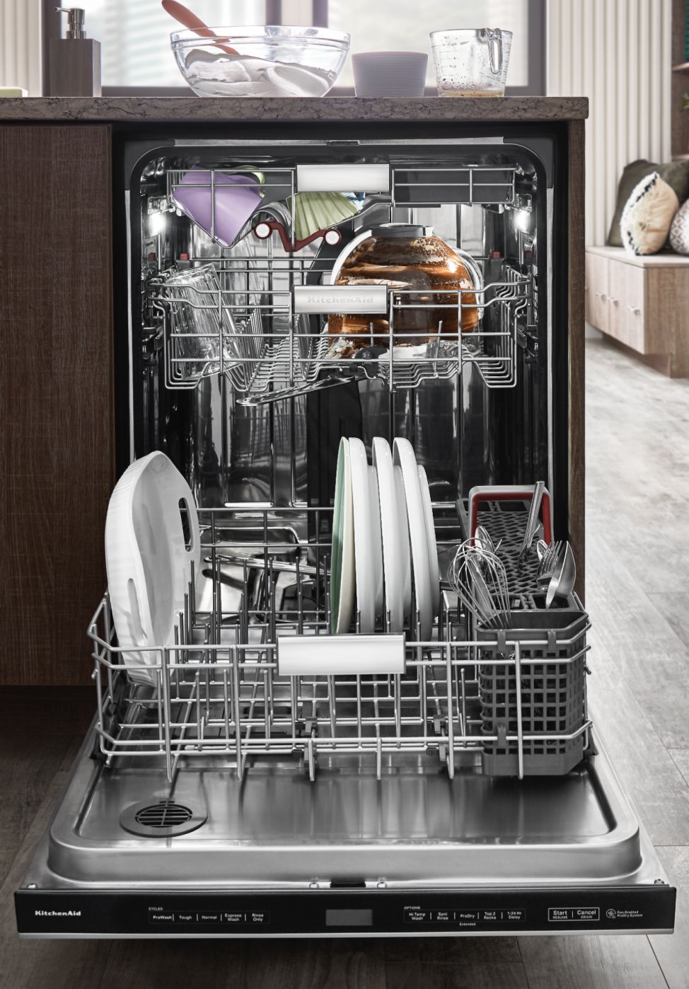A fully loaded FreeFlex™ Third Rack Dishwasher installed in a bright kitchen.