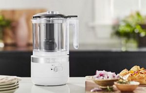 A White Cordless Chopper resting on a bright kitchen counter.