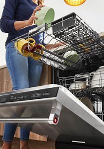 A person unloading their FreeFlex™ Third Rack Dishwasher.