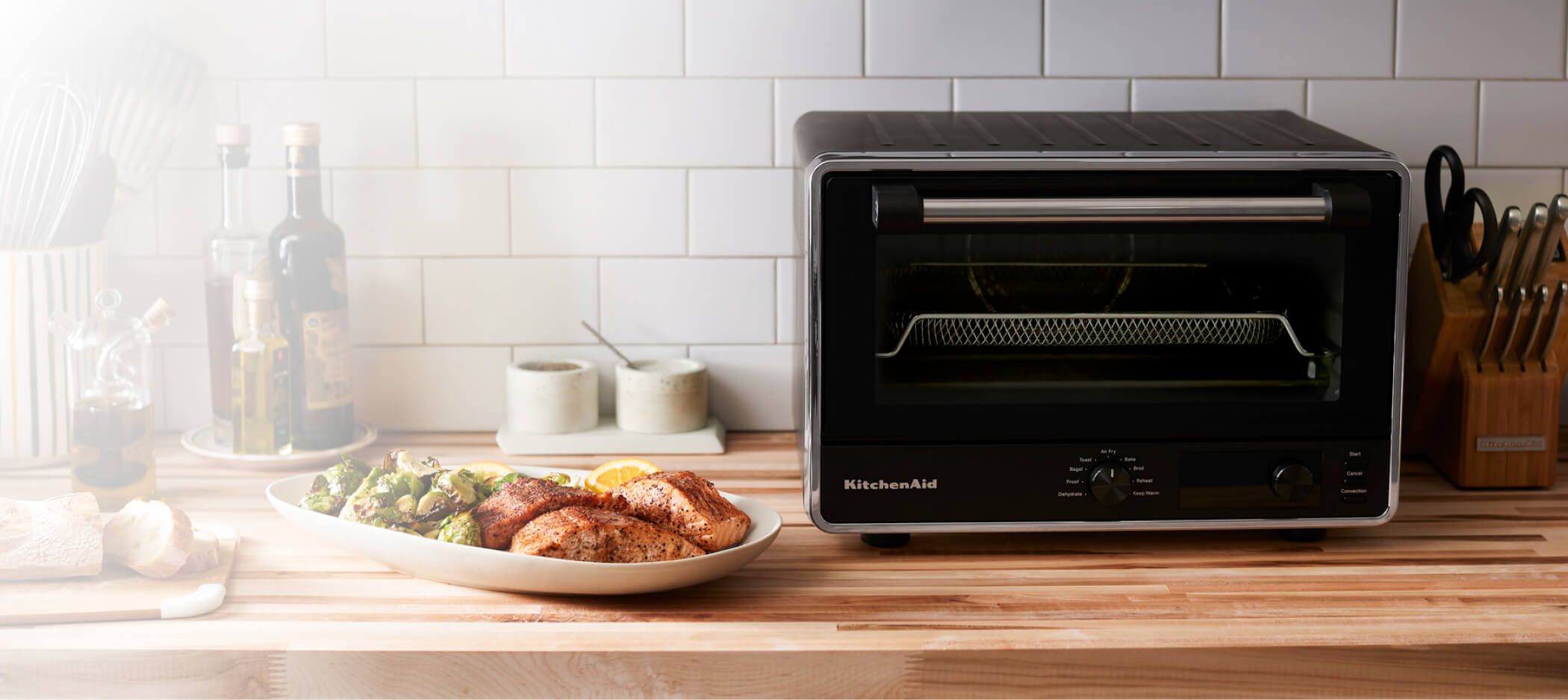 A wooden countertop spotlighting a Digital Countertop Oven with Air Fry.