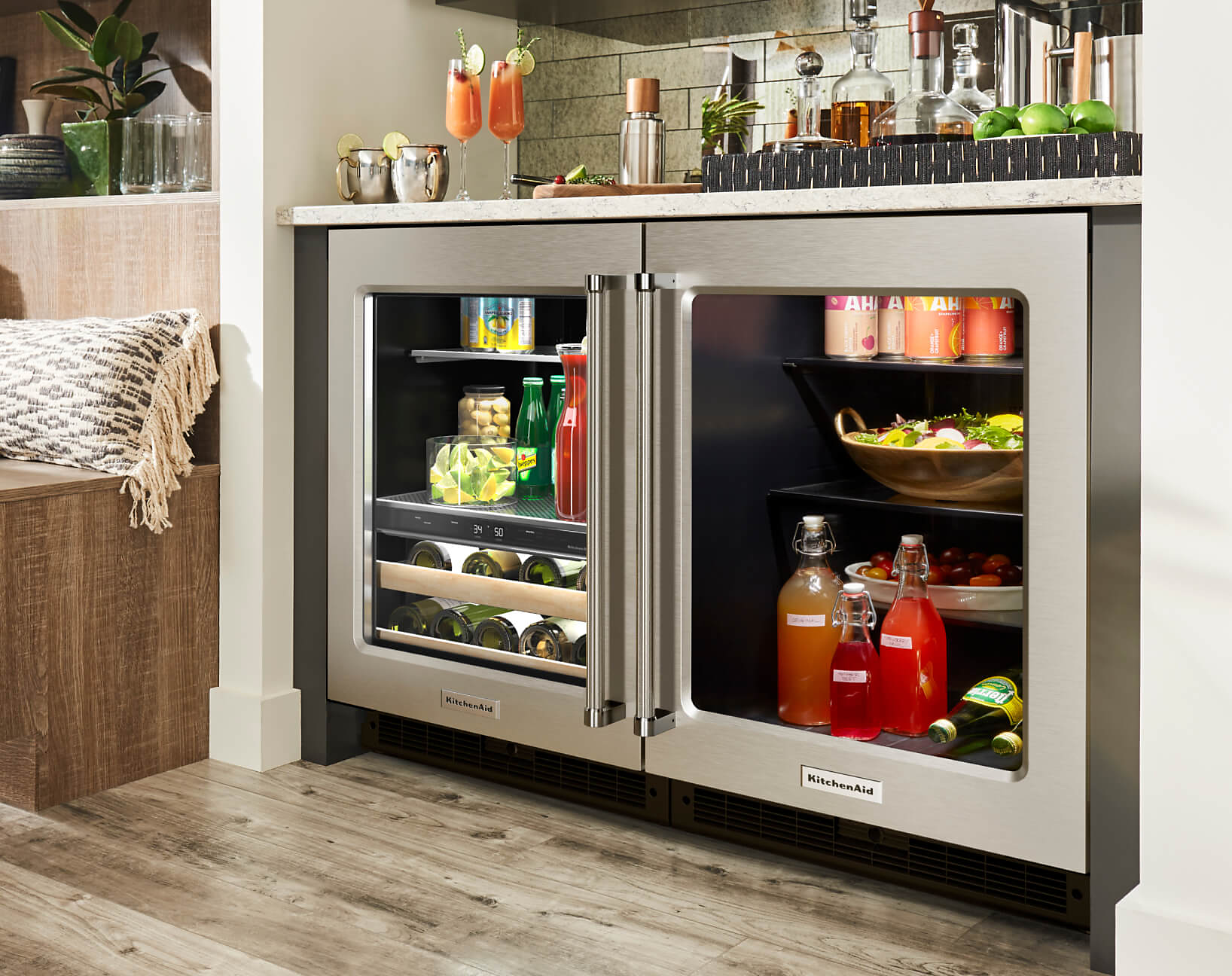The exterior of a KitchenAid® undercounter beverage center and an undercoutner refrigerator.