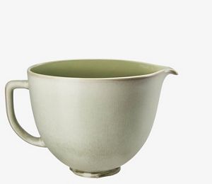 Red stand mixer using fresh prep attachment to cut zucchini into sheets.