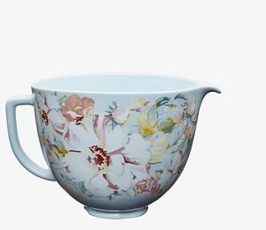 Red stand mixer using fresh prep attachment to cut zucchini into sheets.