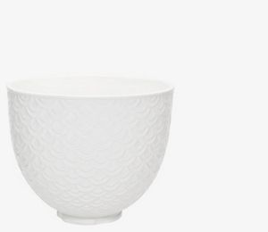 Red stand mixer using fresh prep attachment to cut zucchini into sheets.