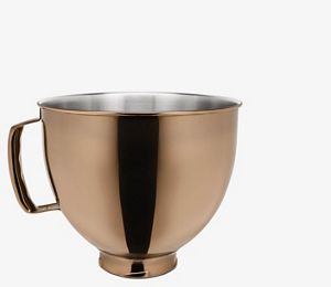 Red stand mixer using fresh prep attachment to cut zucchini into sheets.