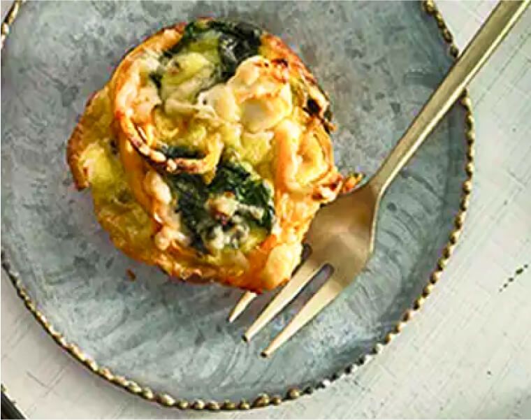 A mini sweet potato and spinach frittata served on a plate.