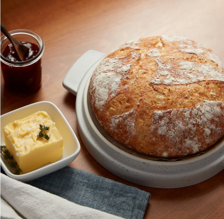 Freshly baked bread served with butter and jam. 