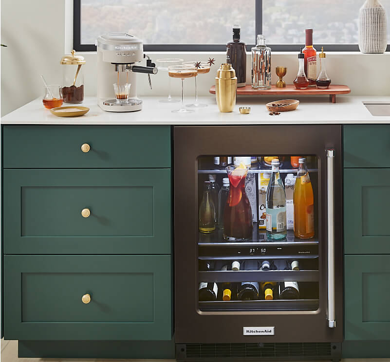 A wet bar decorated with seasonal decor and KitchenAid® appliances making espresso martinis. 