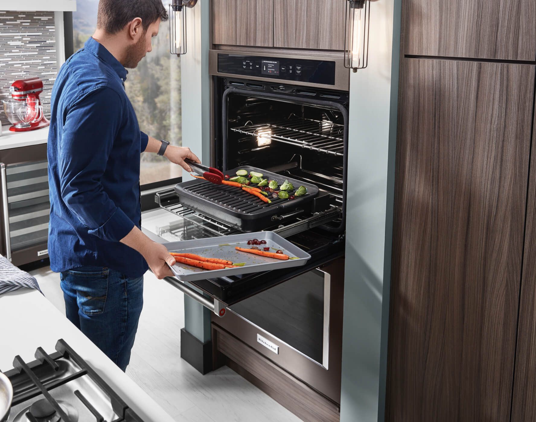 A person placing fresh vegetables on the grilling attachment of a Smart Oven+.