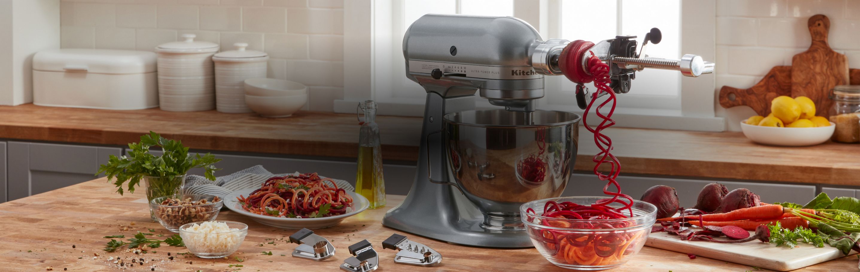 KitchenAid® Stand Mixer w/attachment making beet noodles.