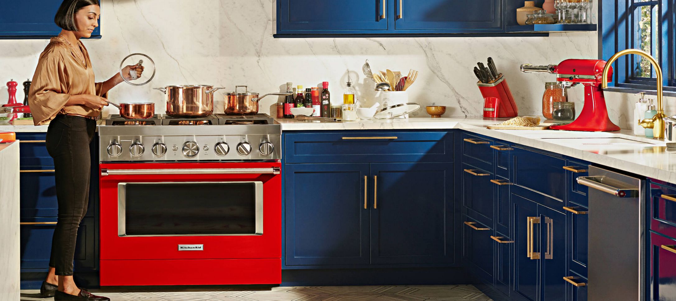 A person cooking with a KitchenAid® Commercial-Style Range.