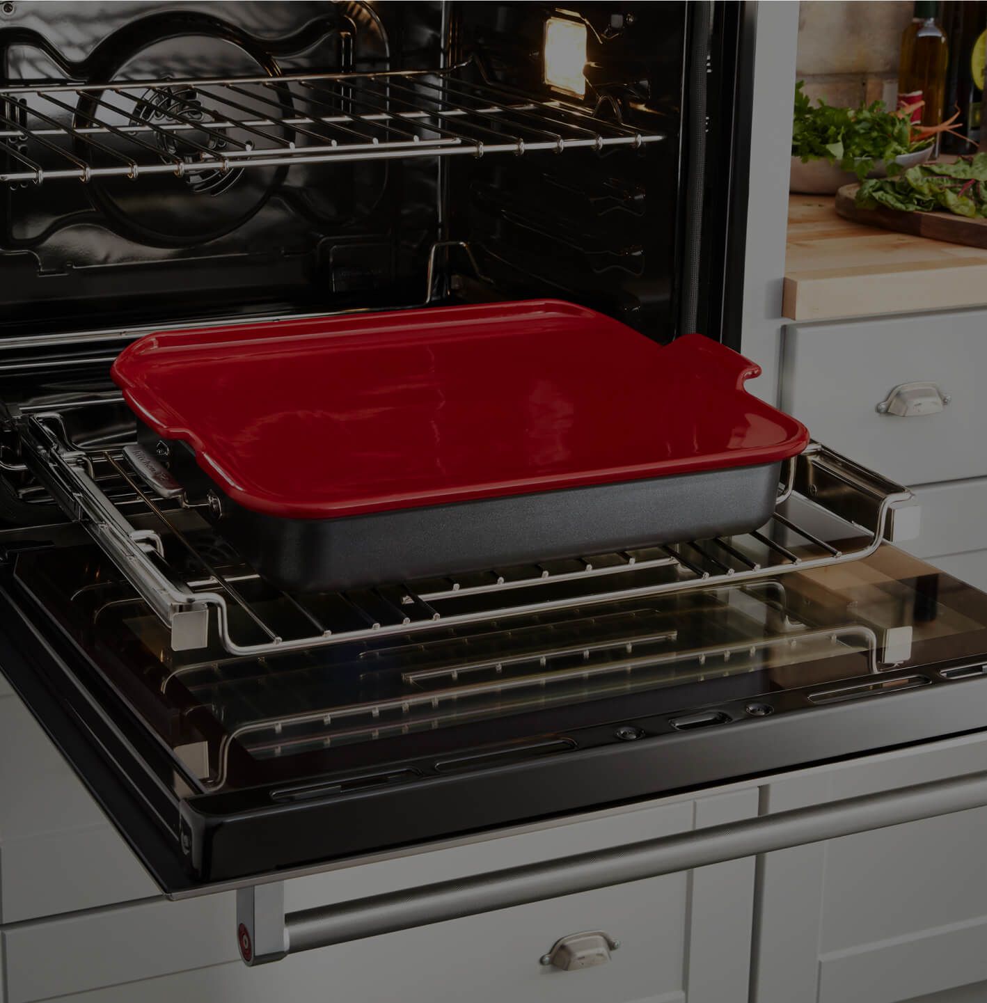 A KitchenAid® Smart Oven+ open with cookware on a rack.