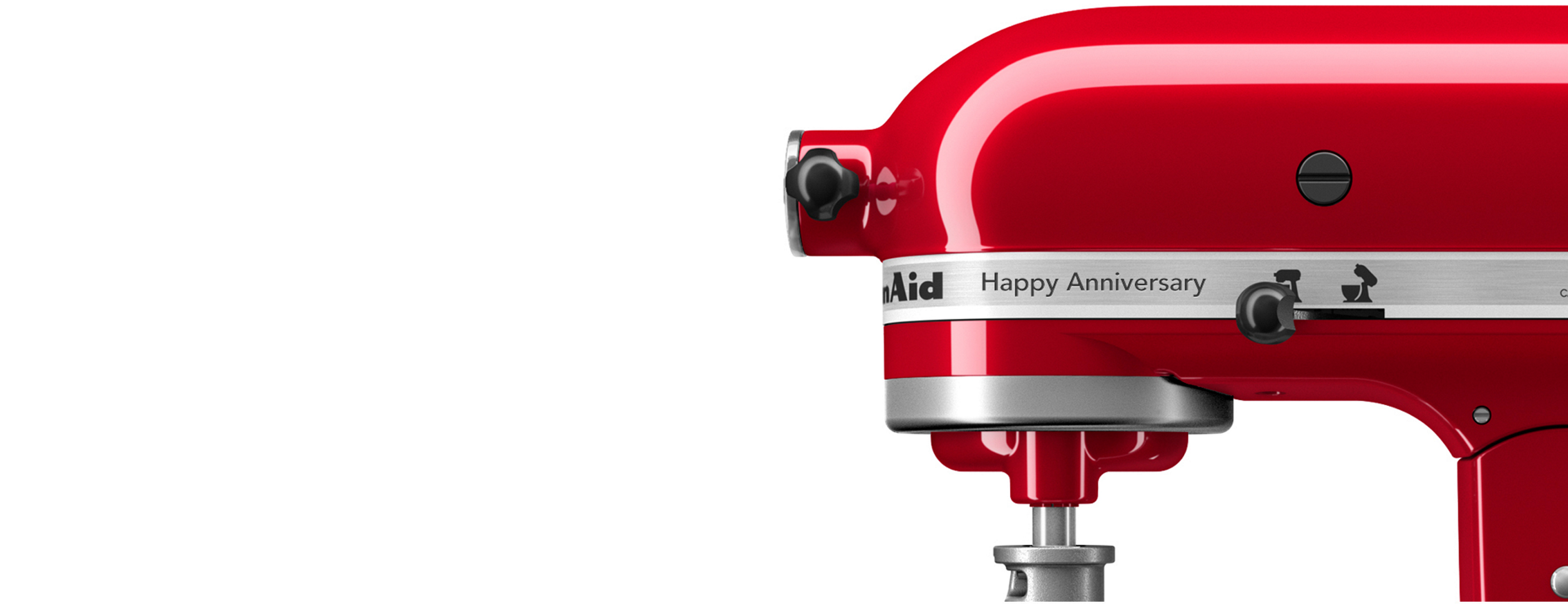 A KitchenAid food processor, loaded with a variety of colorful vegetables. All around it are the signs of preparation, with cut and uncut ingredients in various states of preparation.