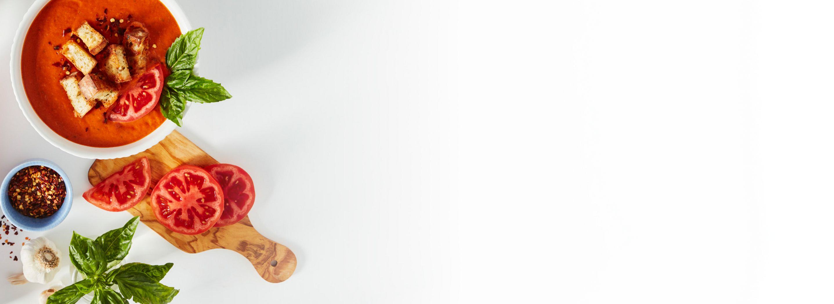 Tomato soup with croutons, basil and fresh tomatoes.