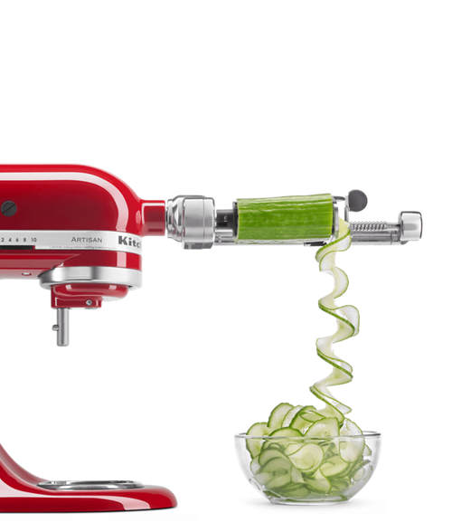 Red stand mixer beautifully spiralizing a fresh cucumber.
