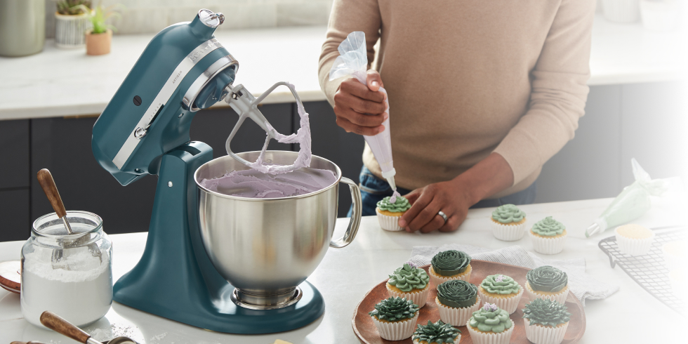 A maker using the KitchenAid® Agave Stand Mixer to frost cupcakes like succulent plants. 