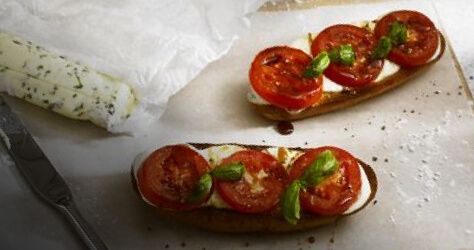 Plate with tomatoes and mozzarella cheese on toast.