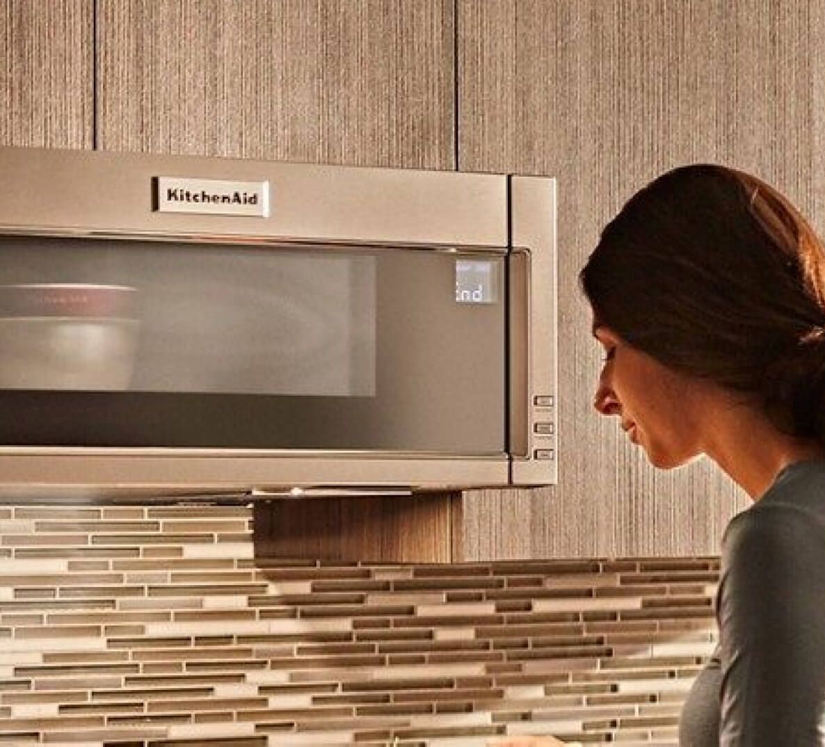 Woman standing in front of built-in microwave