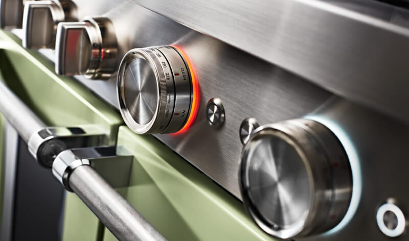 Closeup of knobs on an Avocado Cream range.