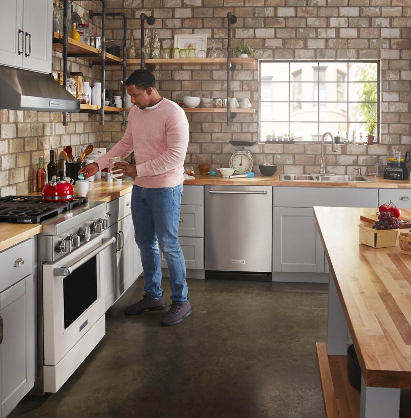 A person making coffee in modern kitchen.