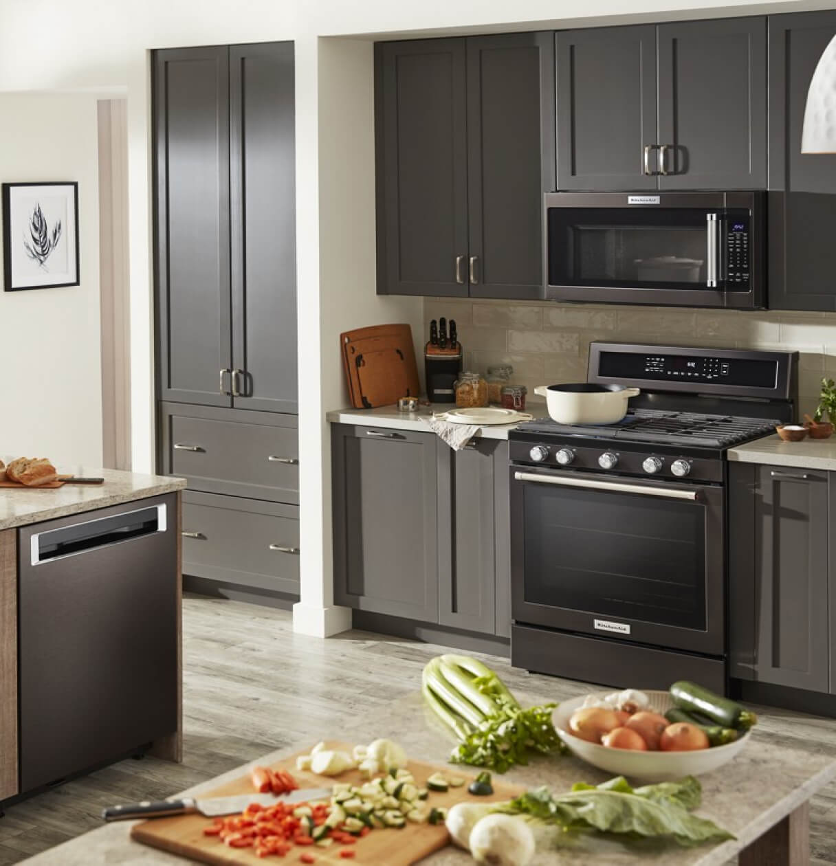 Black stainless appliances in a kitchen with grey cabinets.