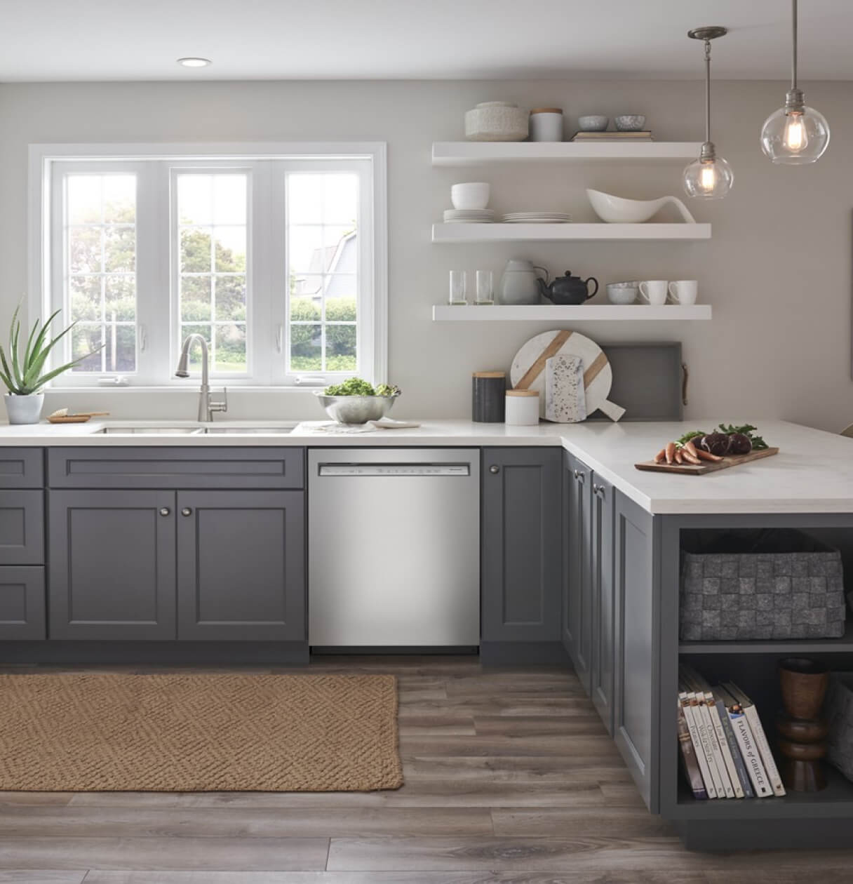 Light kitchen with dark grey cabinets and stainless dishwasher