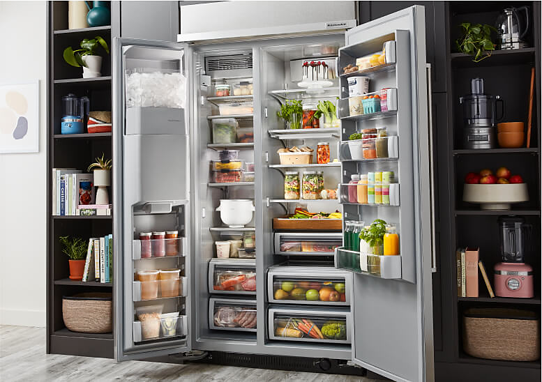 An open 48" KitchenAid® Built-In Side-by-Side Refrigerator KBSD706M filled with fresh produce and ingredients 