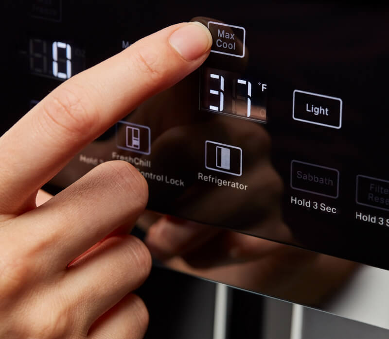 A person selecting the Max Cool control on the KitchenAid® Built-In Side-by-Side Refrigerator