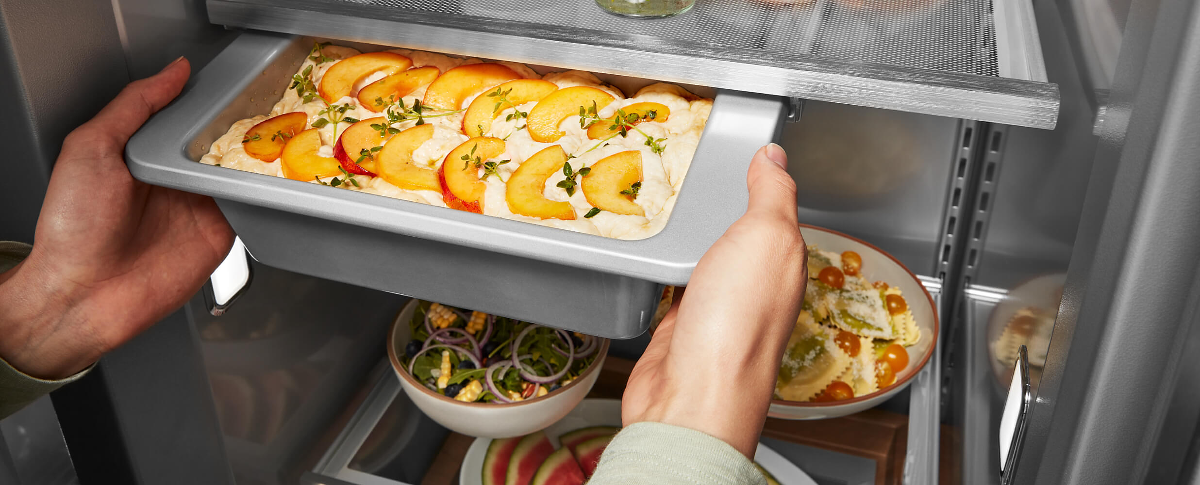 36" KitchenAid® Built-In Side-by-Side Refrigerator Under-Shelf Prep Zone holding a peach dessert  