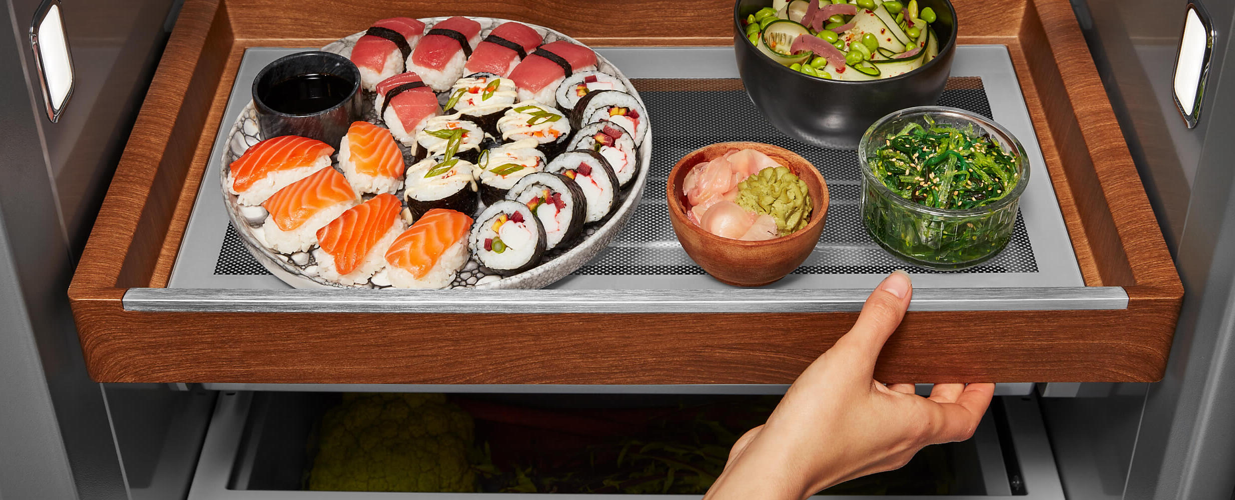 Sliding Storage Tray in a 36" KitchenAid® Built-In Side-by-Side Refrigerator holding sushi and other foods
