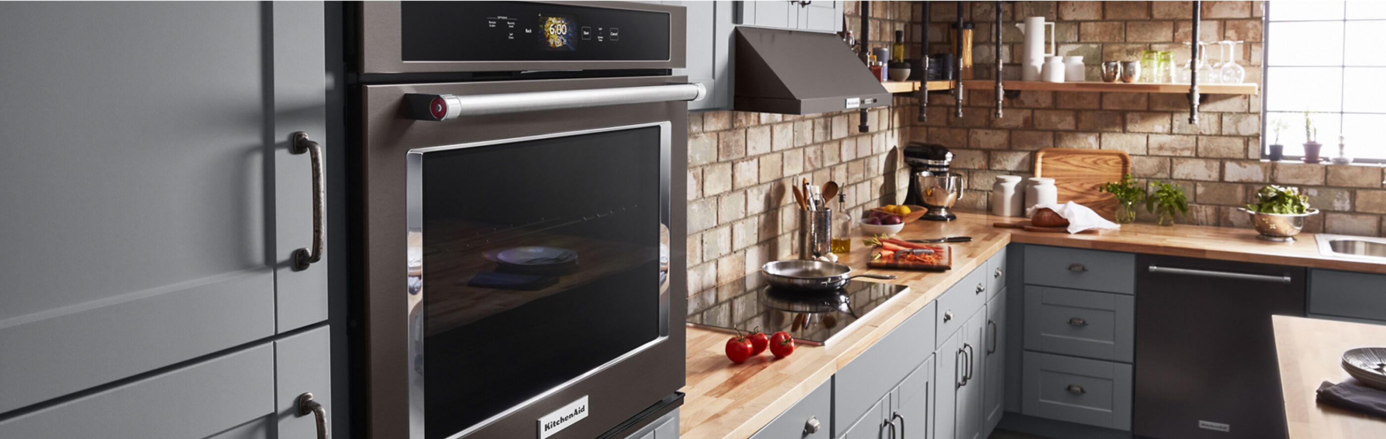 A well-stocked kitchen featuring a KitchenAid® Wall Oven.