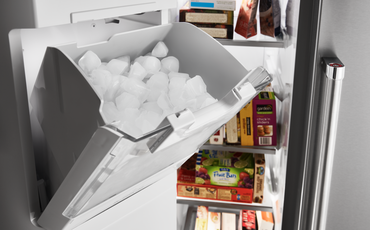 A full ice bin in a KitchenAid refrigerator.