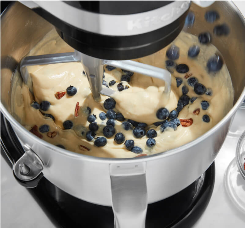The interior of a KitchenAid® Bowl-Lift Bowl, folding fresh berries into dough. 