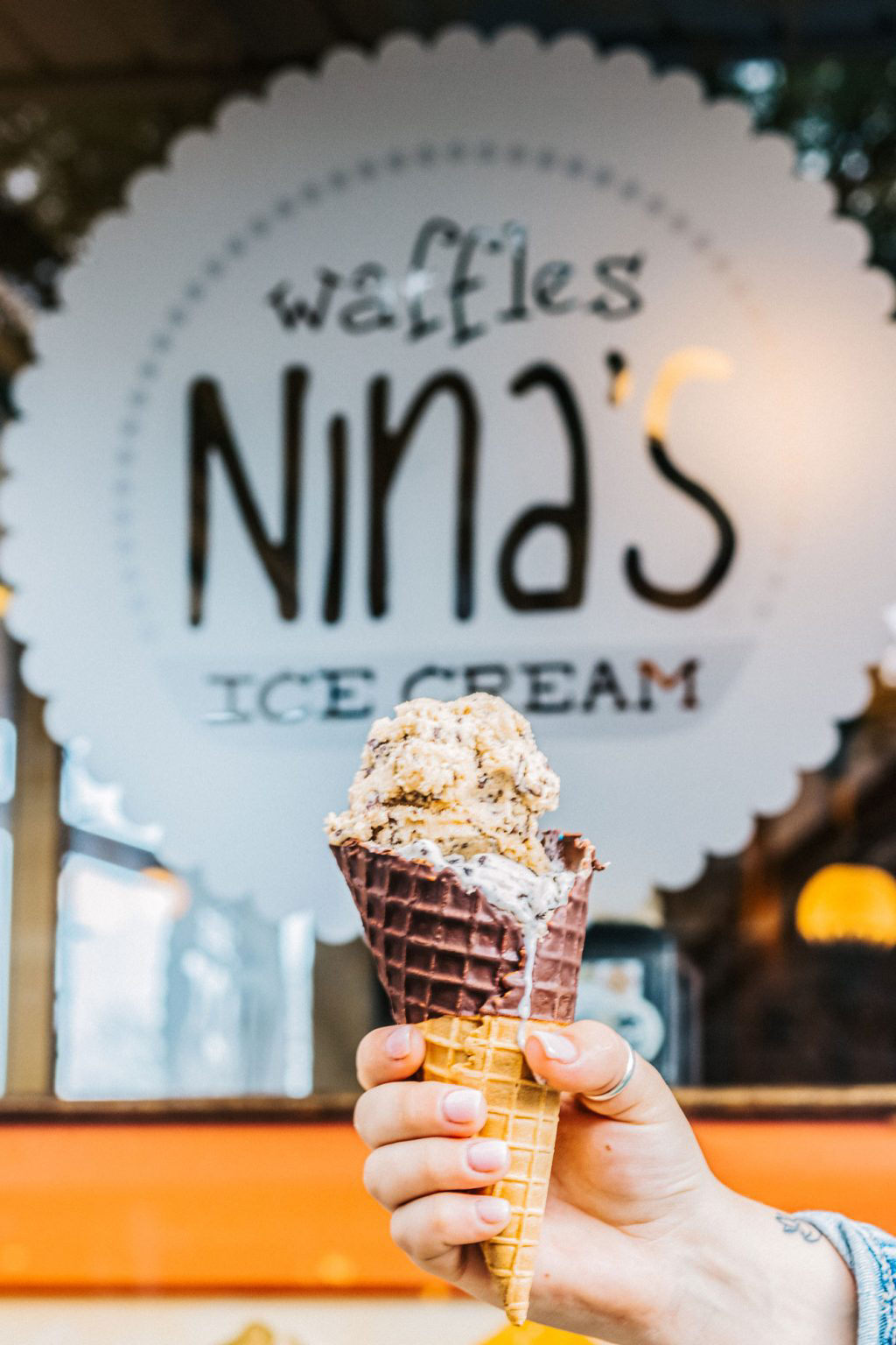 A chocolate cone topped with ice cream from Nina's Ice Cream.