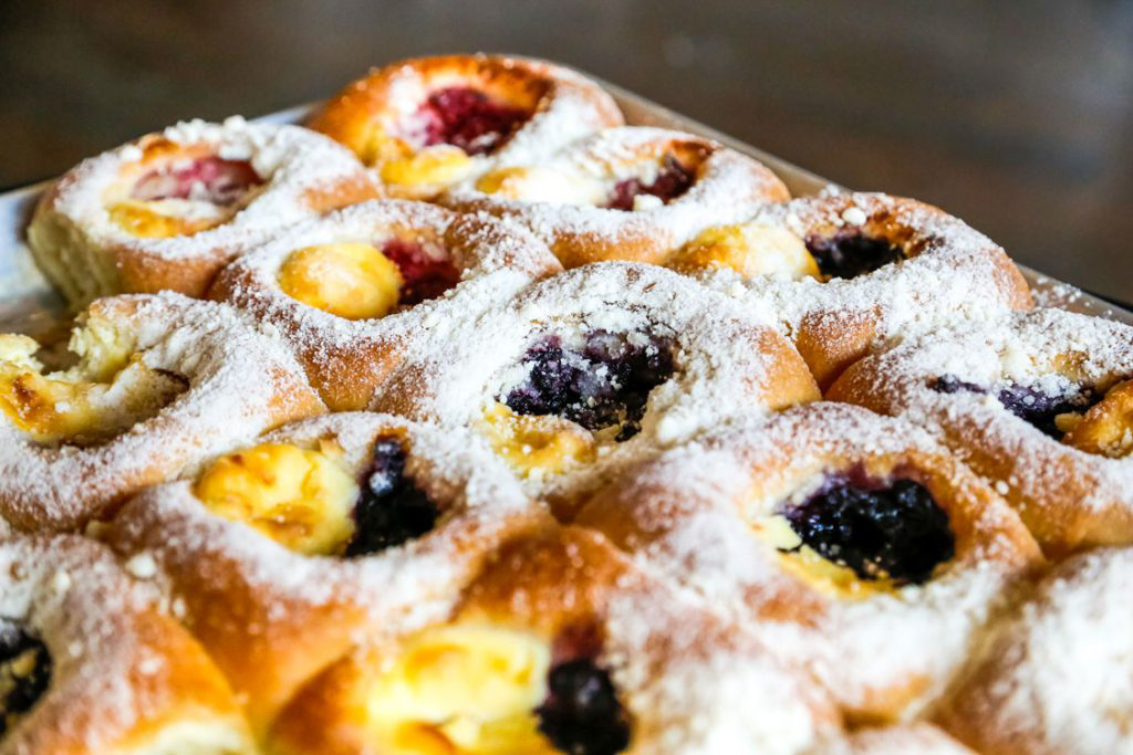 Kolaches topped with powdered sugar.