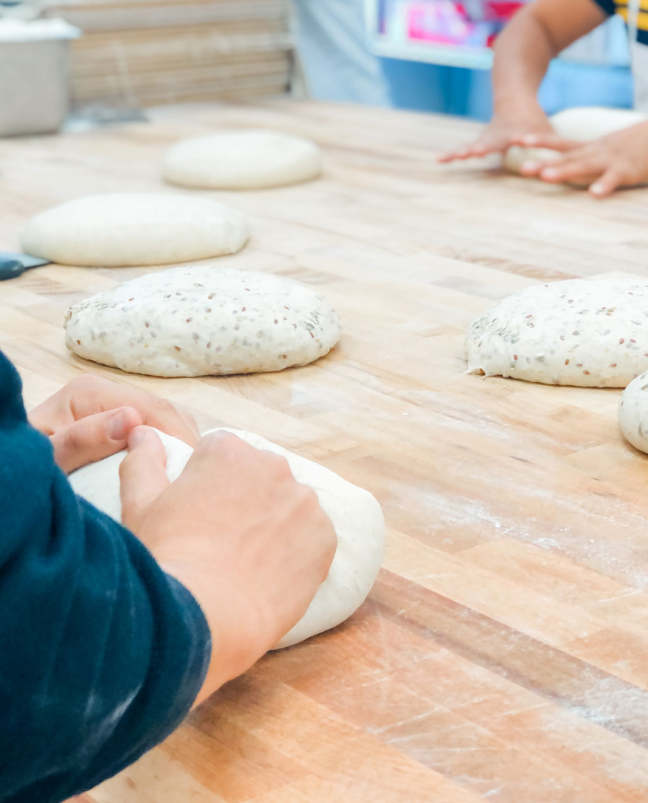 People gently making dough.