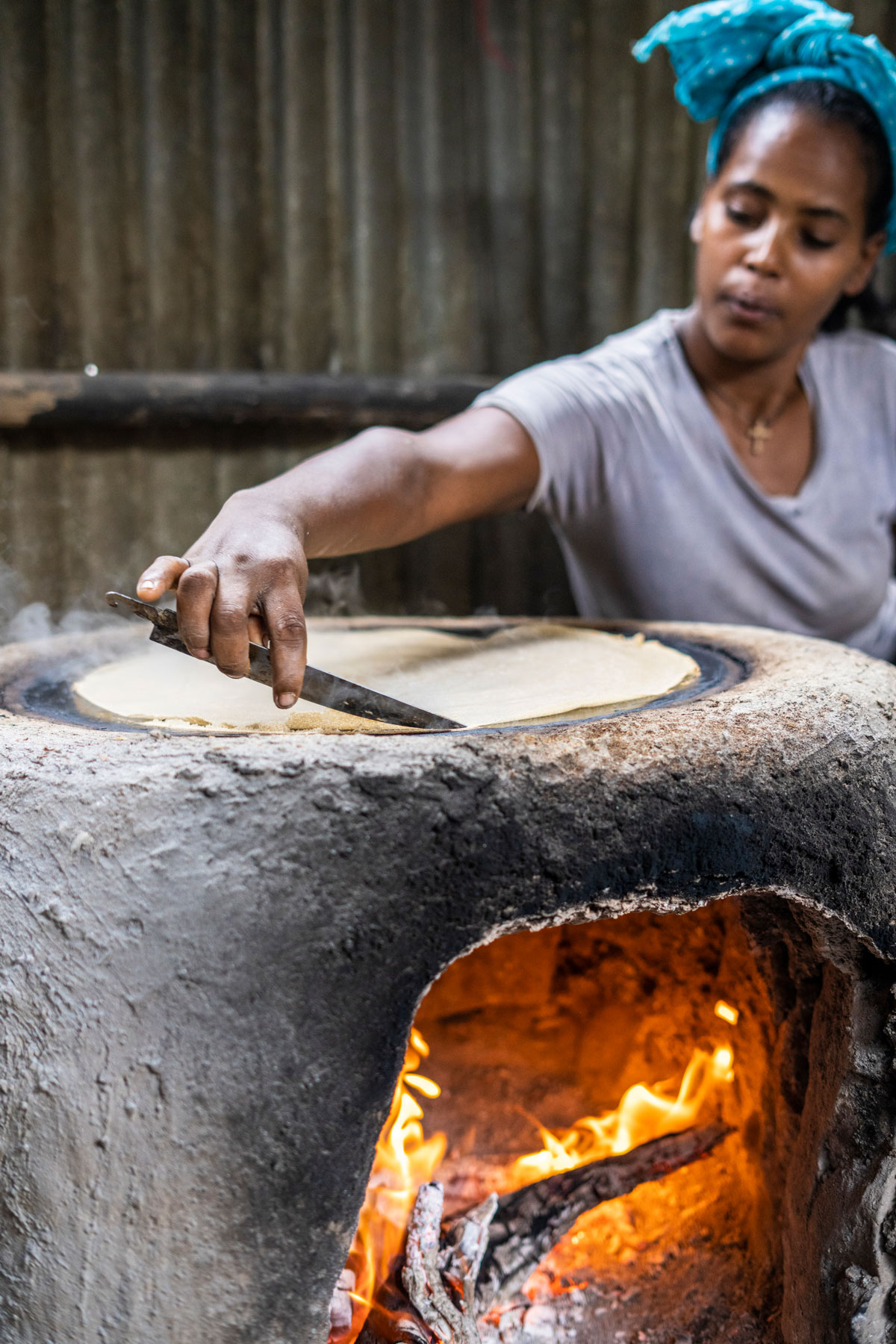 A person making Ethiopian flatbread.